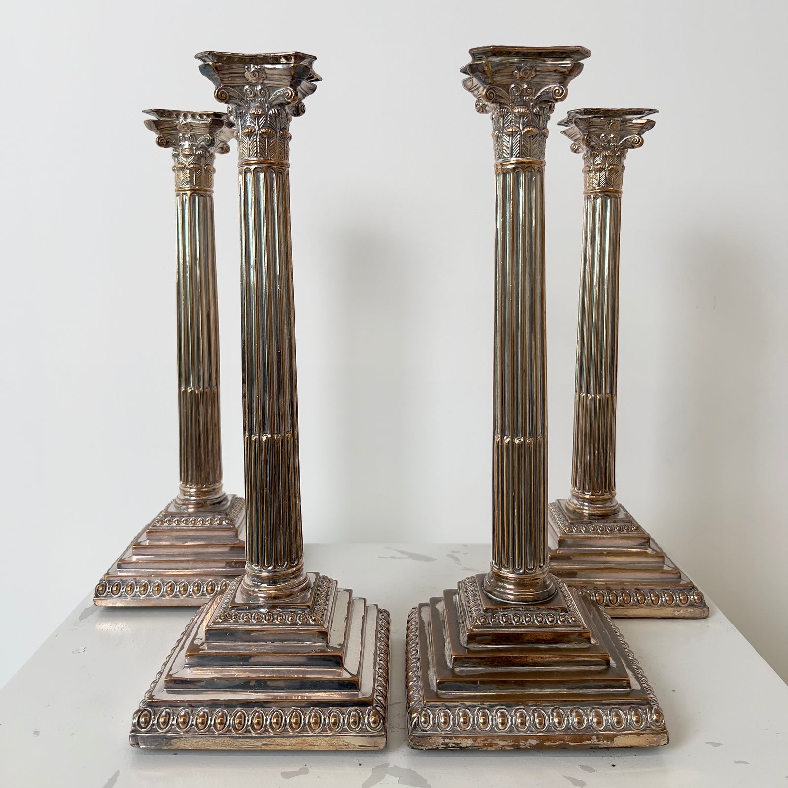 CORINTHIAN COLUMN SILVER-PLATED CANDLESTICKS - FOUR