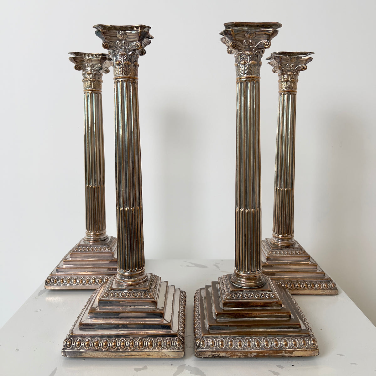 CORINTHIAN COLUMN SILVER-PLATED CANDLESTICKS - FOUR
